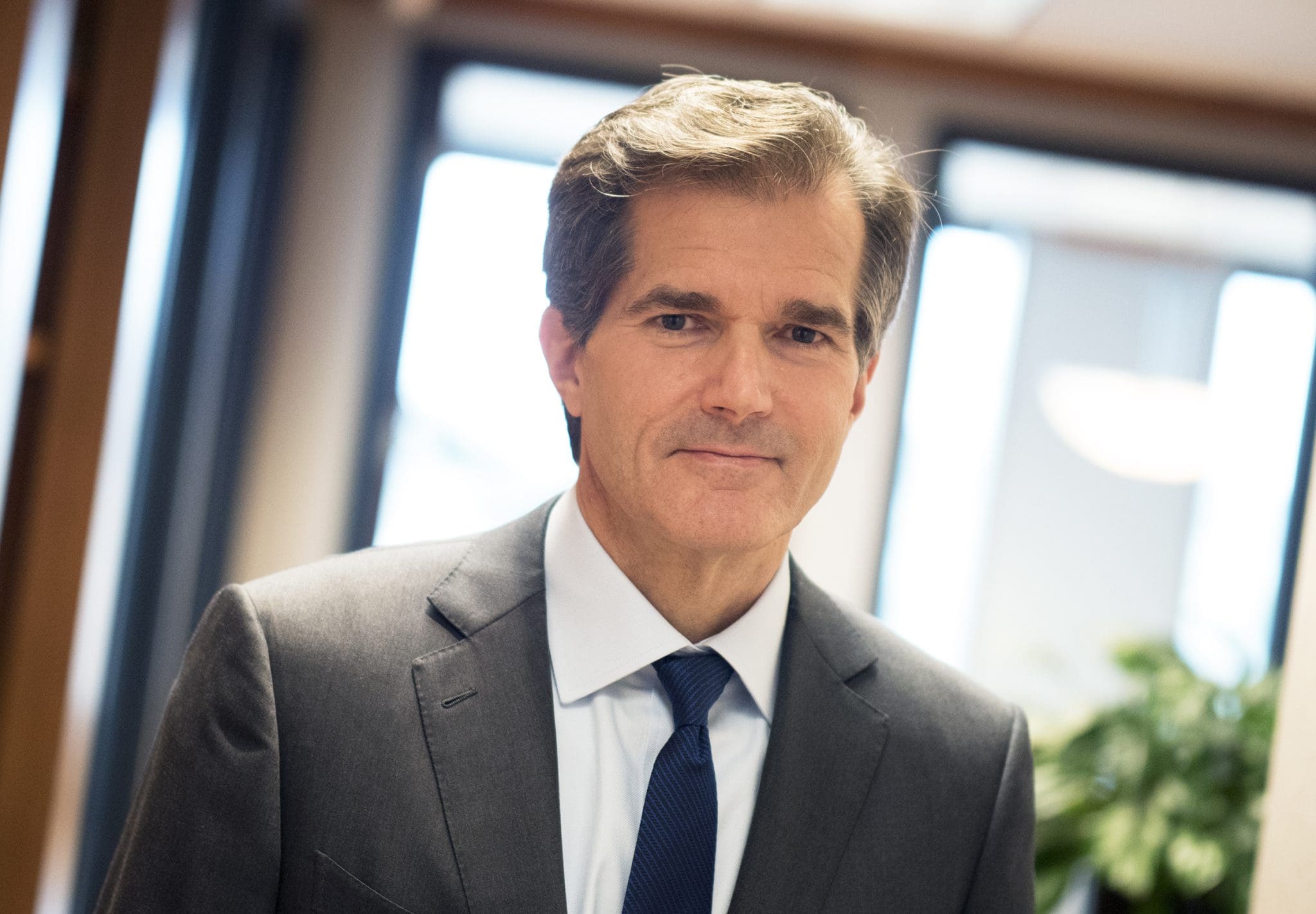 Kenneth J. Krogulski, Director, wearing a suit and tie, looking confidently into the camera in a professional office environment.