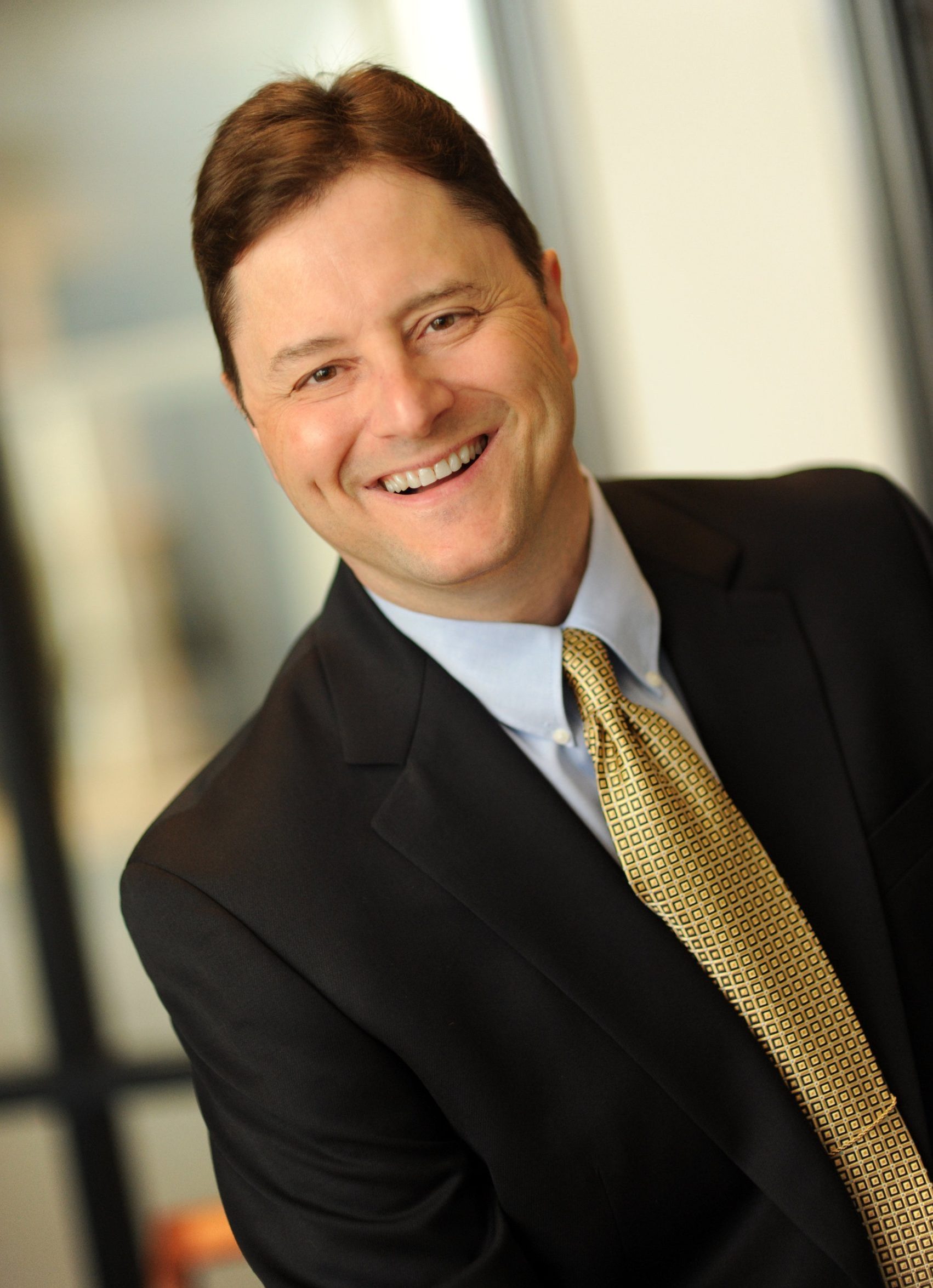 Todd Anthony, Vice President of Organizational Development, smiling in a suit and patterned tie.